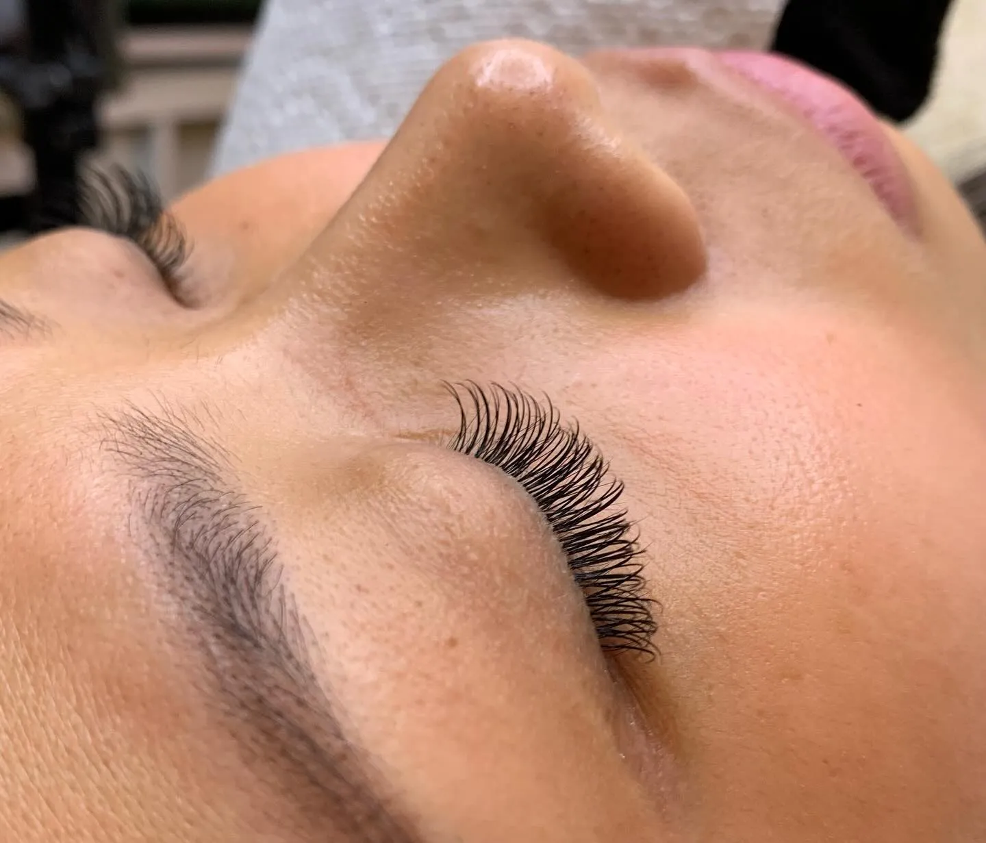 Side angle view of closed eye lash extensions